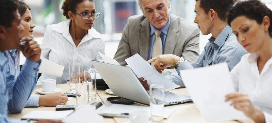 business people discussing work on laptop at meeting