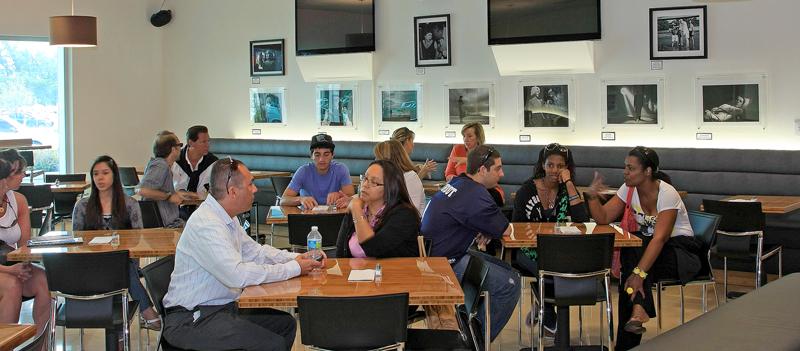 People sit at tables in a cafe